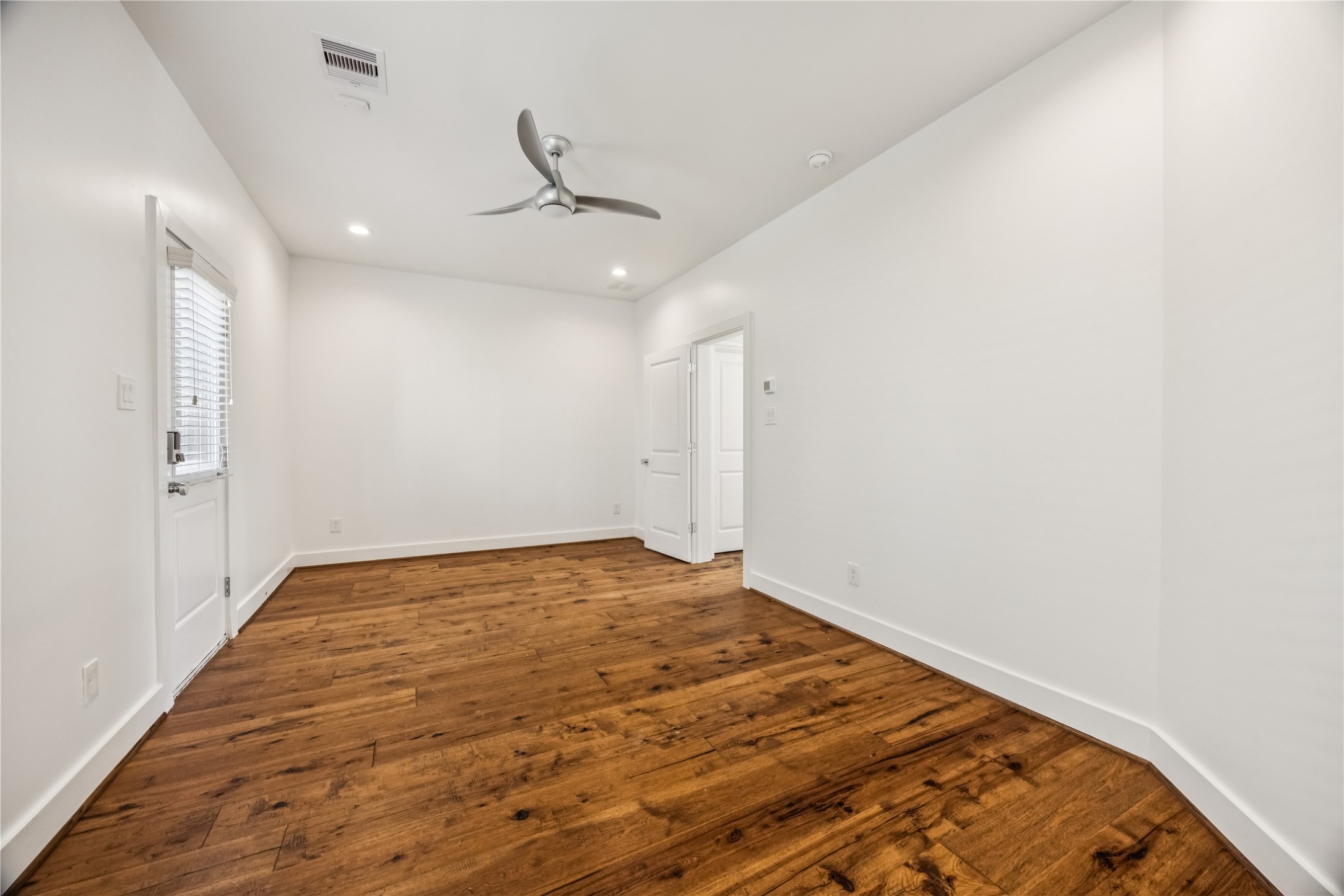 1812 West Webster Street Houston, TX 77019 - Photo 4 of 23 an empty room with wooden floor and fan