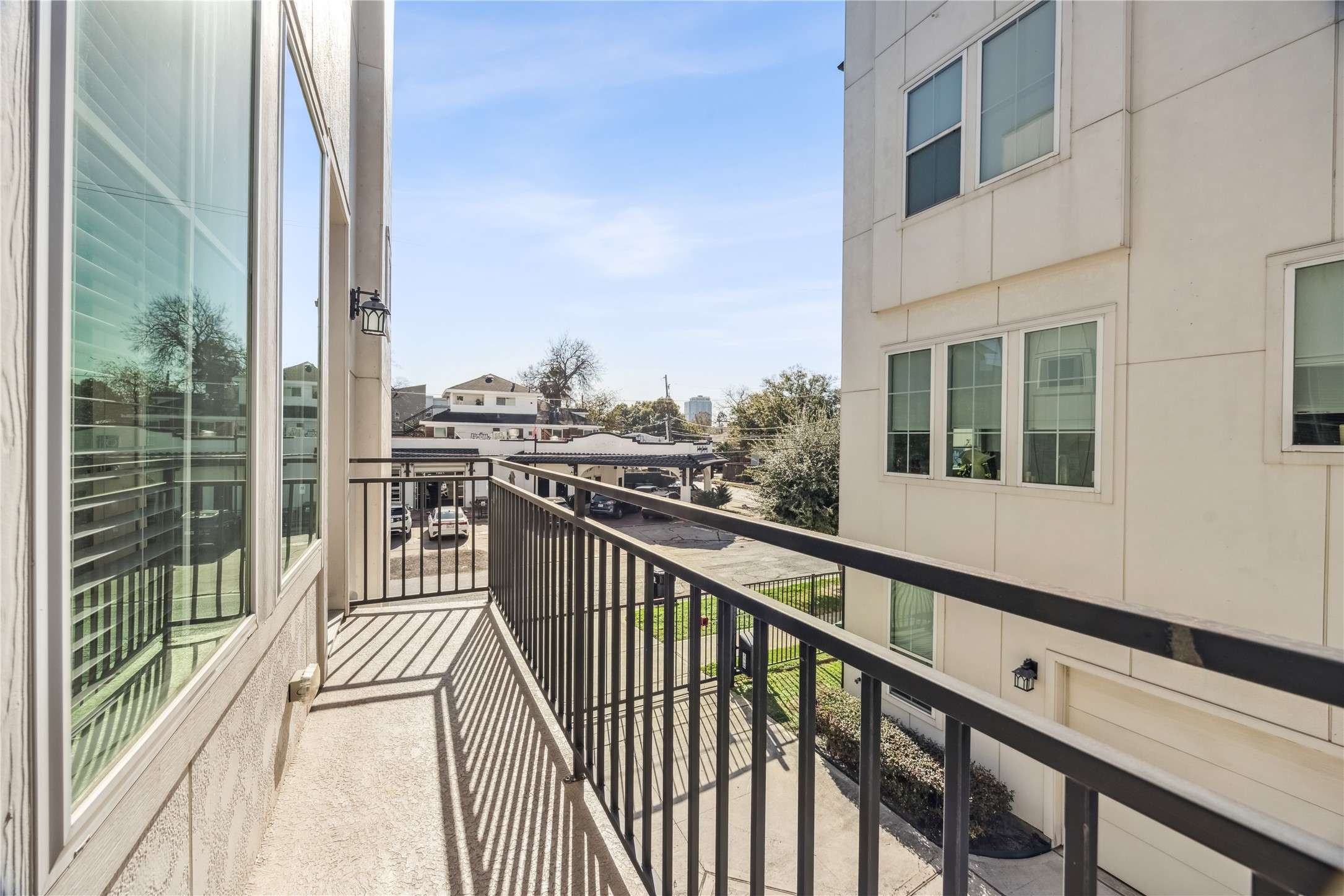 1812 West Webster Street Houston, TX 77019 - Photo 9 of 23 a view of a balcony with wooden floor and fence