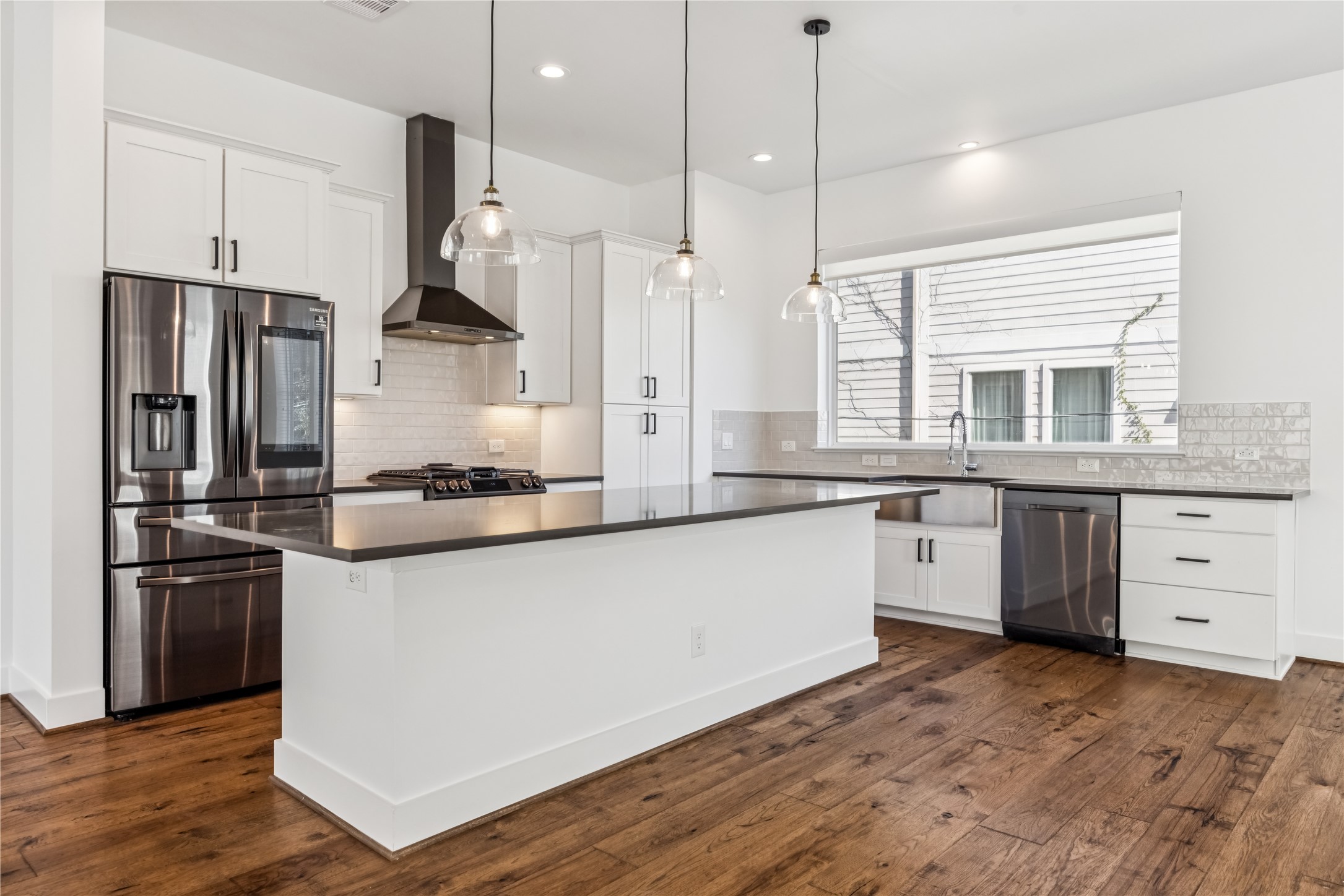 1812 West Webster Street Houston, TX 77019 - Photo 10 of 23 a kitchen with stainless steel appliances granite countertop a sink a stove and a refrigerator