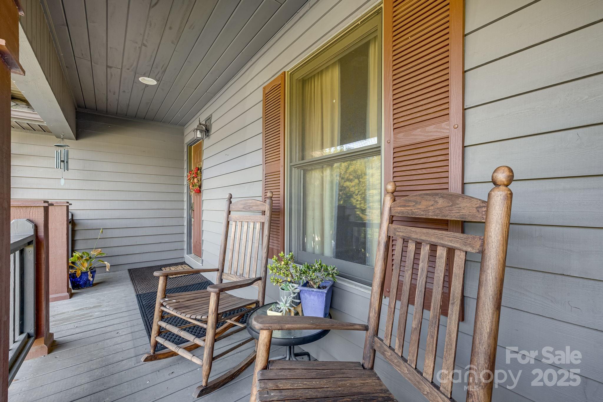 57 Stillwater Springs Road Burnsville, NC 28714 - Photo 11 of 48 a view of a balcony with chairs and a potted plant