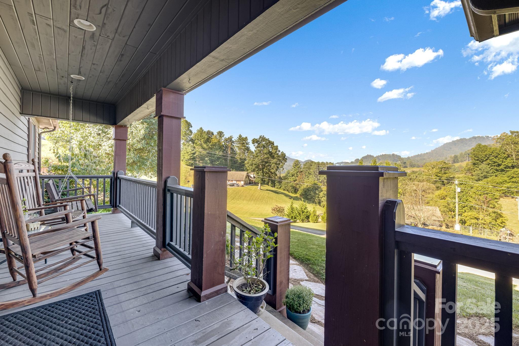 57 Stillwater Springs Road Burnsville, NC 28714 - Photo 13 of 48 a view of a balcony with furniture and wooden floor