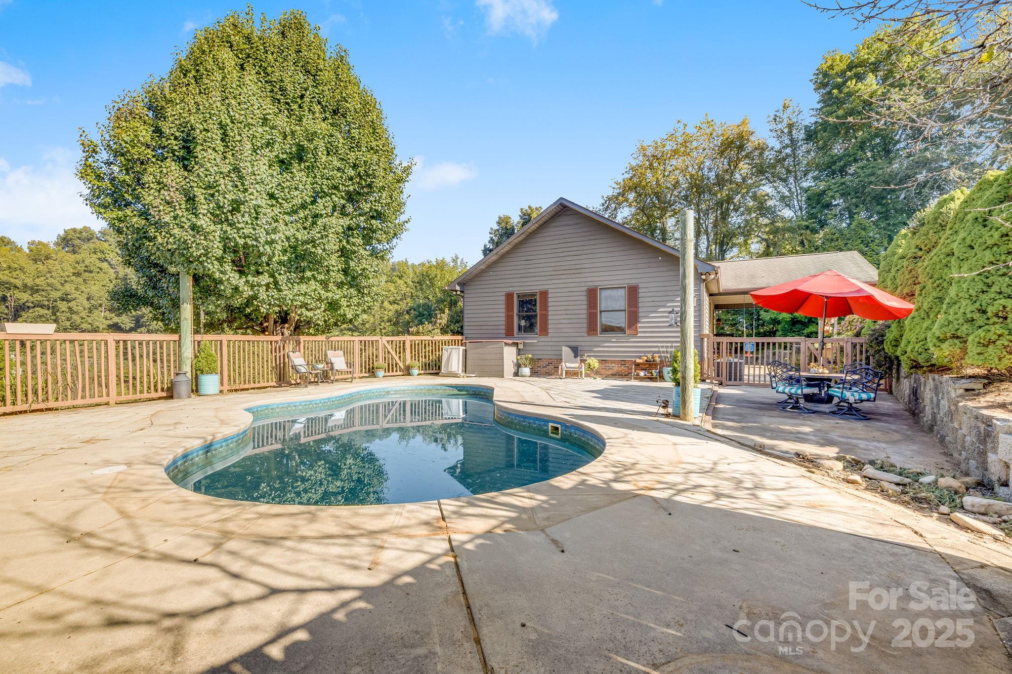 57 Stillwater Springs Road Burnsville, NC 28714 - Photo 17 of 48 a view of a house with swimming pool and sitting area