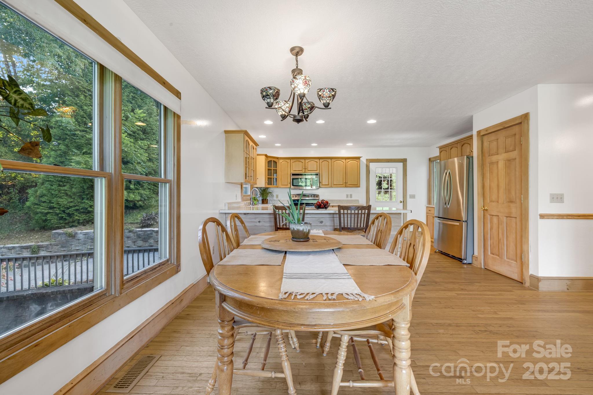 57 Stillwater Springs Road Burnsville, NC 28714 - Photo 21 of 48 a view of a dining room with furniture window and wooden floor