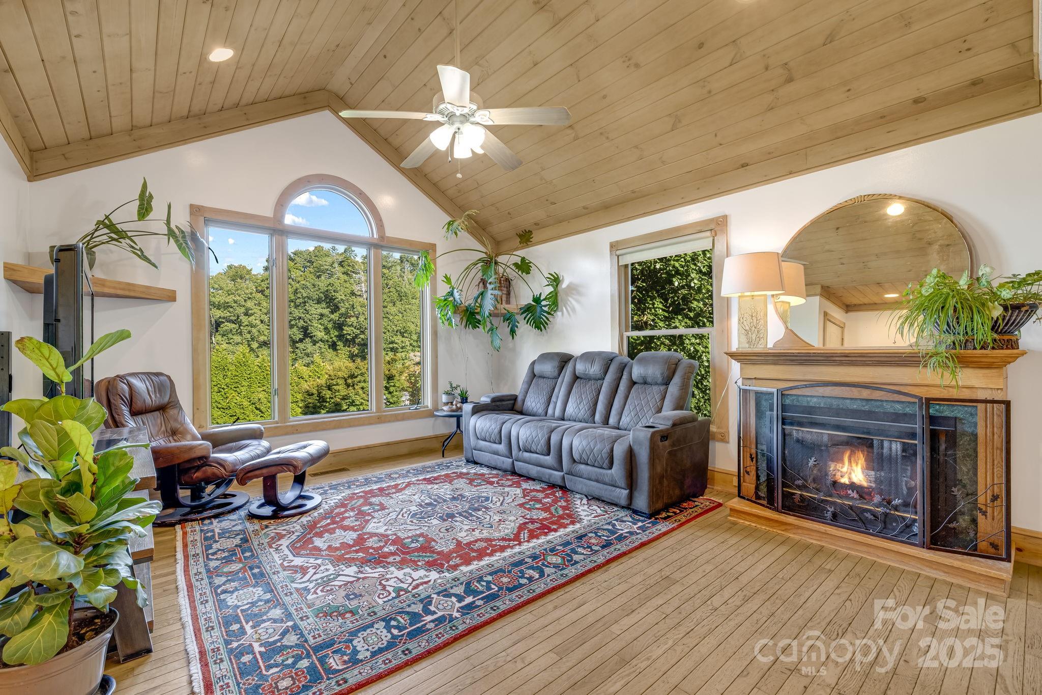 57 Stillwater Springs Road Burnsville, NC 28714 - Photo 22 of 48 a living room with furniture and a fireplace