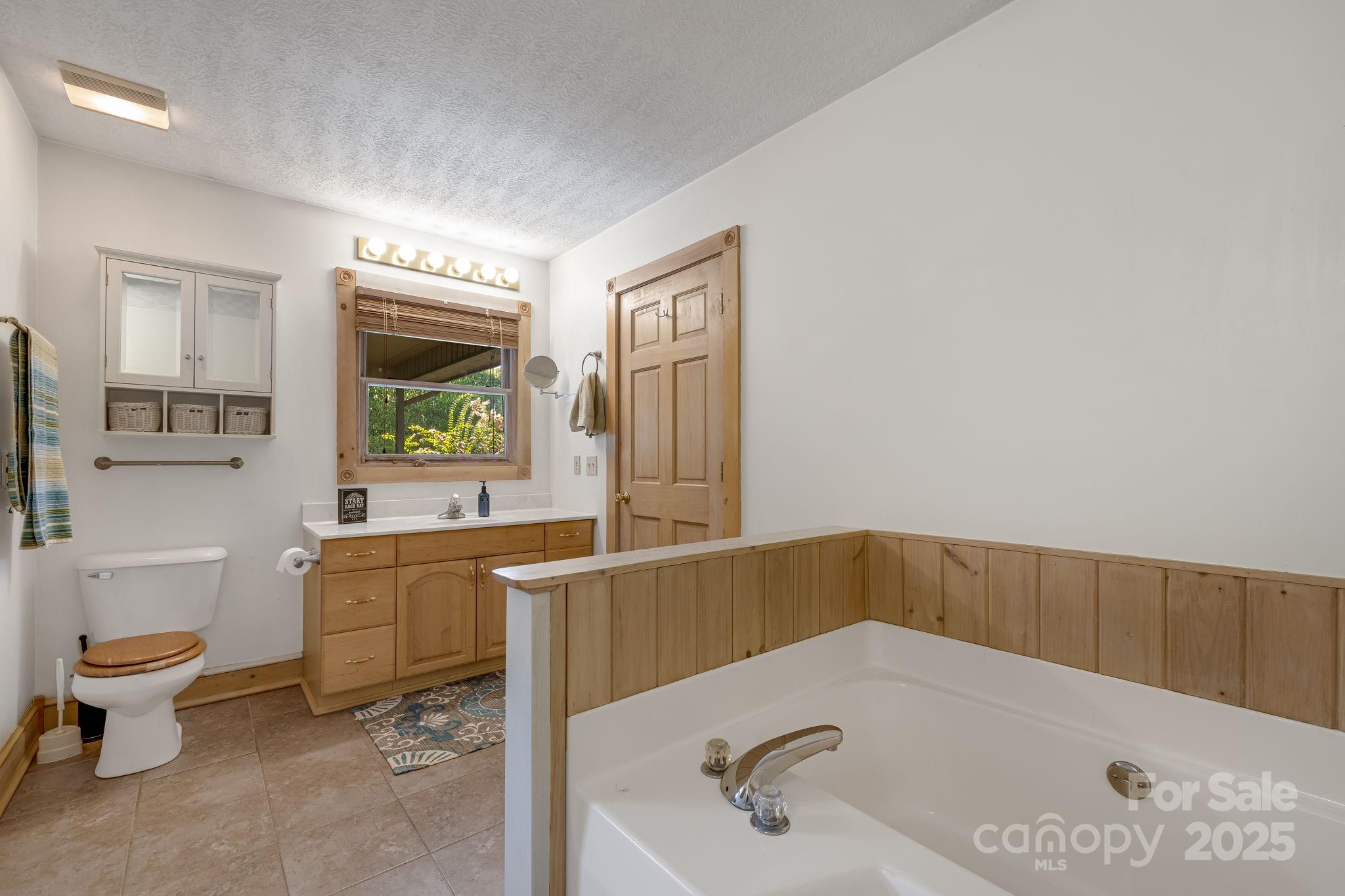57 Stillwater Springs Road Burnsville, NC 28714 - Photo 29 of 48 a bathroom with a sink and a bathtub
