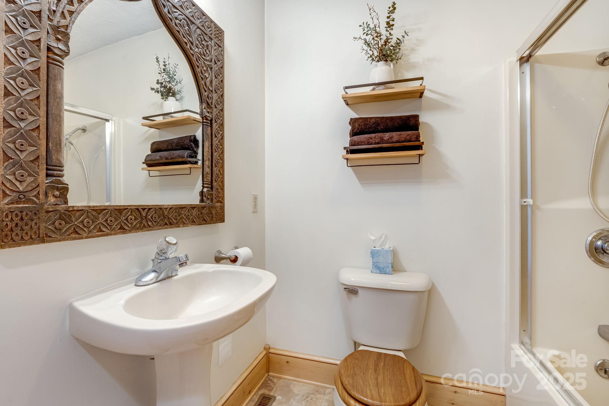 57 Stillwater Springs Road Burnsville, NC 28714 - Photo 33 of 48 a bathroom with a sink a mirror and a toilet