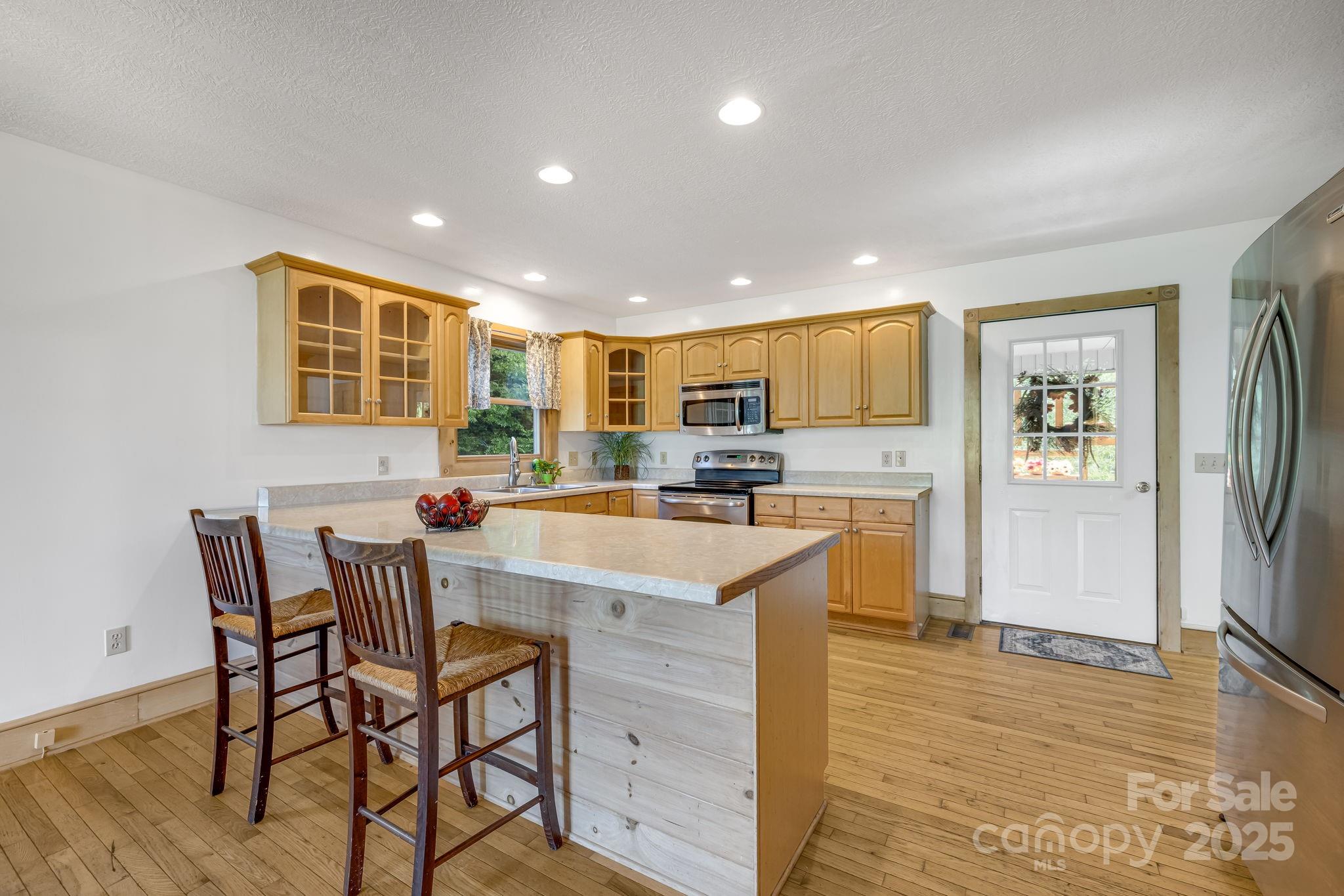 57 Stillwater Springs Road Burnsville, NC 28714 - Photo 4 of 48 a kitchen with stainless steel appliances granite countertop a sink and a refrigerator