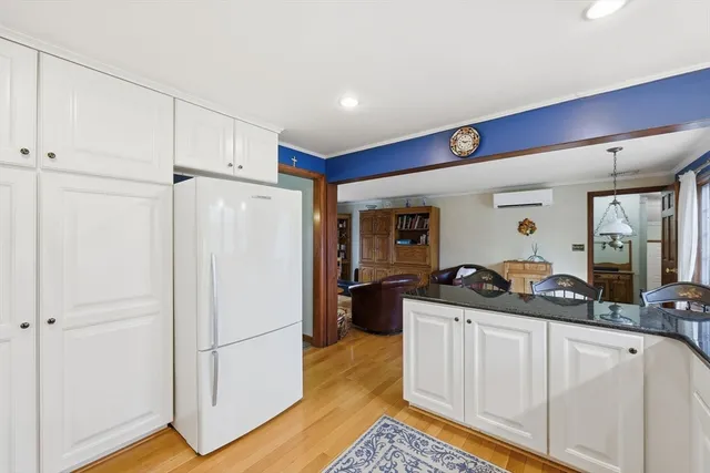 a living room with furniture a flat screen tv and a window