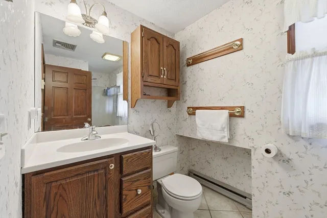 a living room with furniture a fireplace and a chandelier