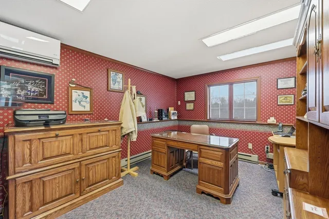 a bathroom with a toilet sink a mirror and a window
