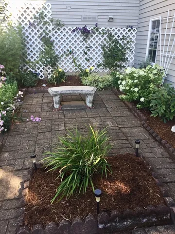 a view of a house with a flower garden