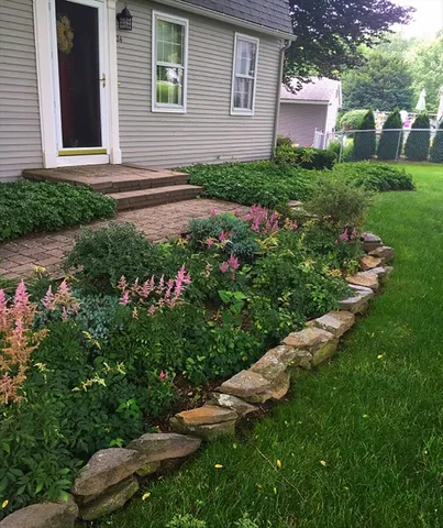 a view of a house with a yard and a garden
