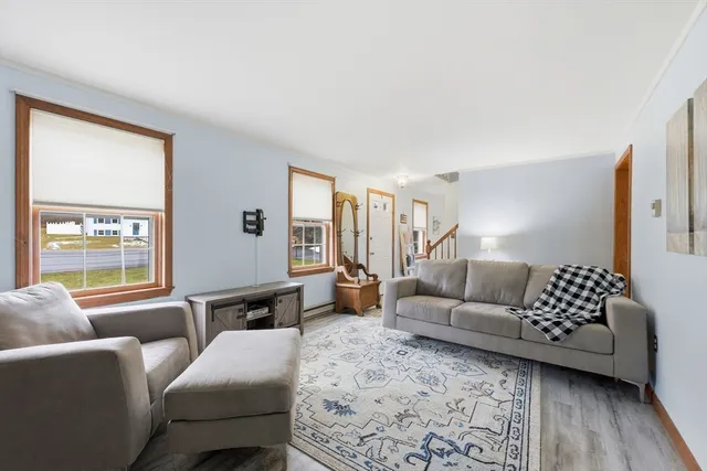a dining room with furniture window and wooden floor