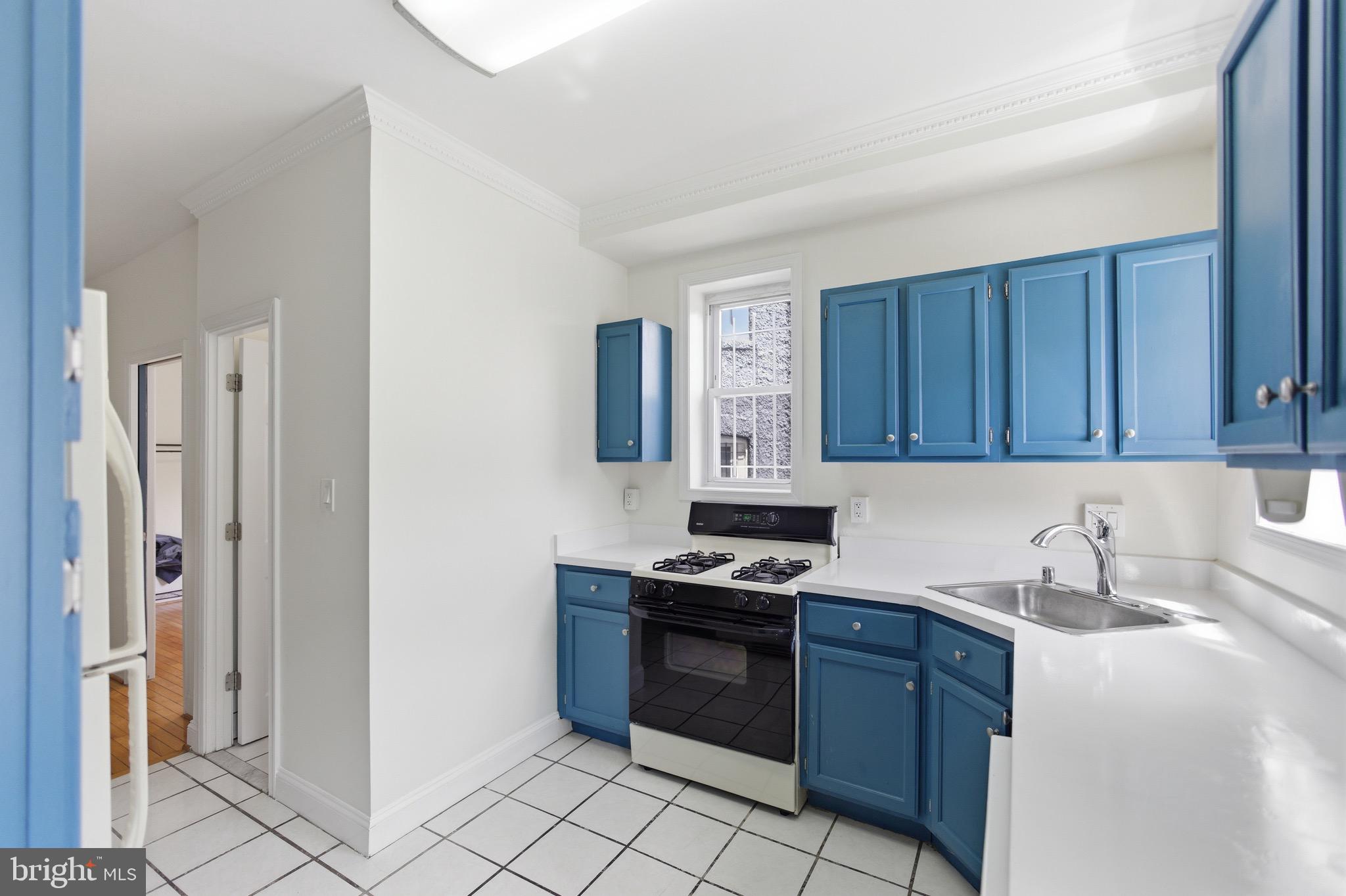 636 Columbia Road Northwest Washington, DC 20001 - Photo 14 of 60 a kitchen with stainless steel appliances granite countertop a stove a sink and a refrigerator
