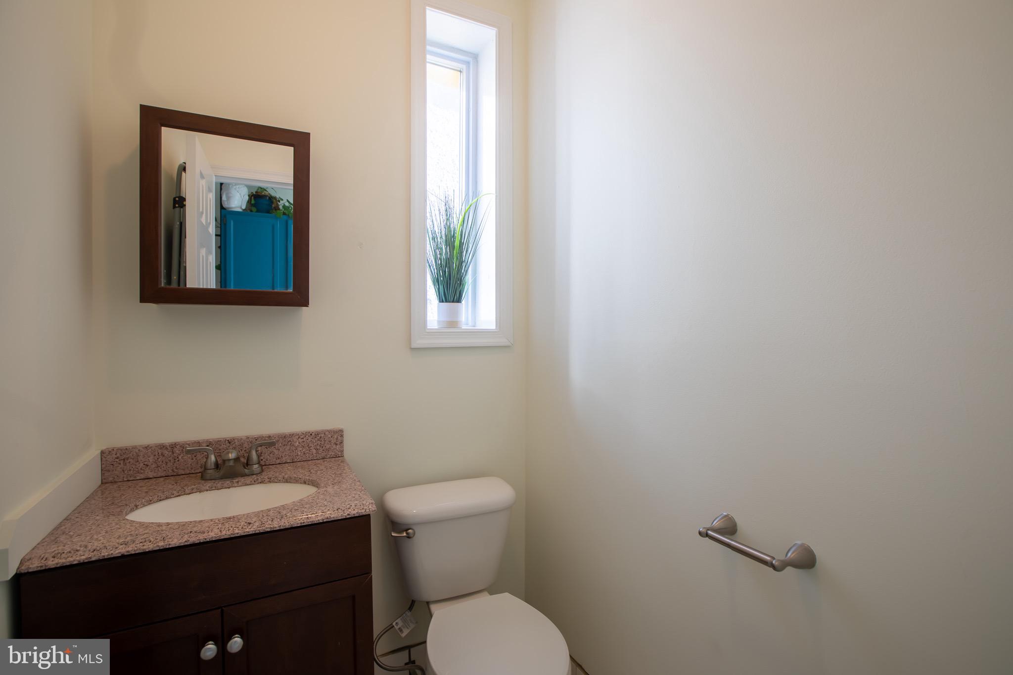636 Columbia Road Northwest Washington, DC 20001 - Photo 15 of 60 a bathroom with a toilet sink and mirror