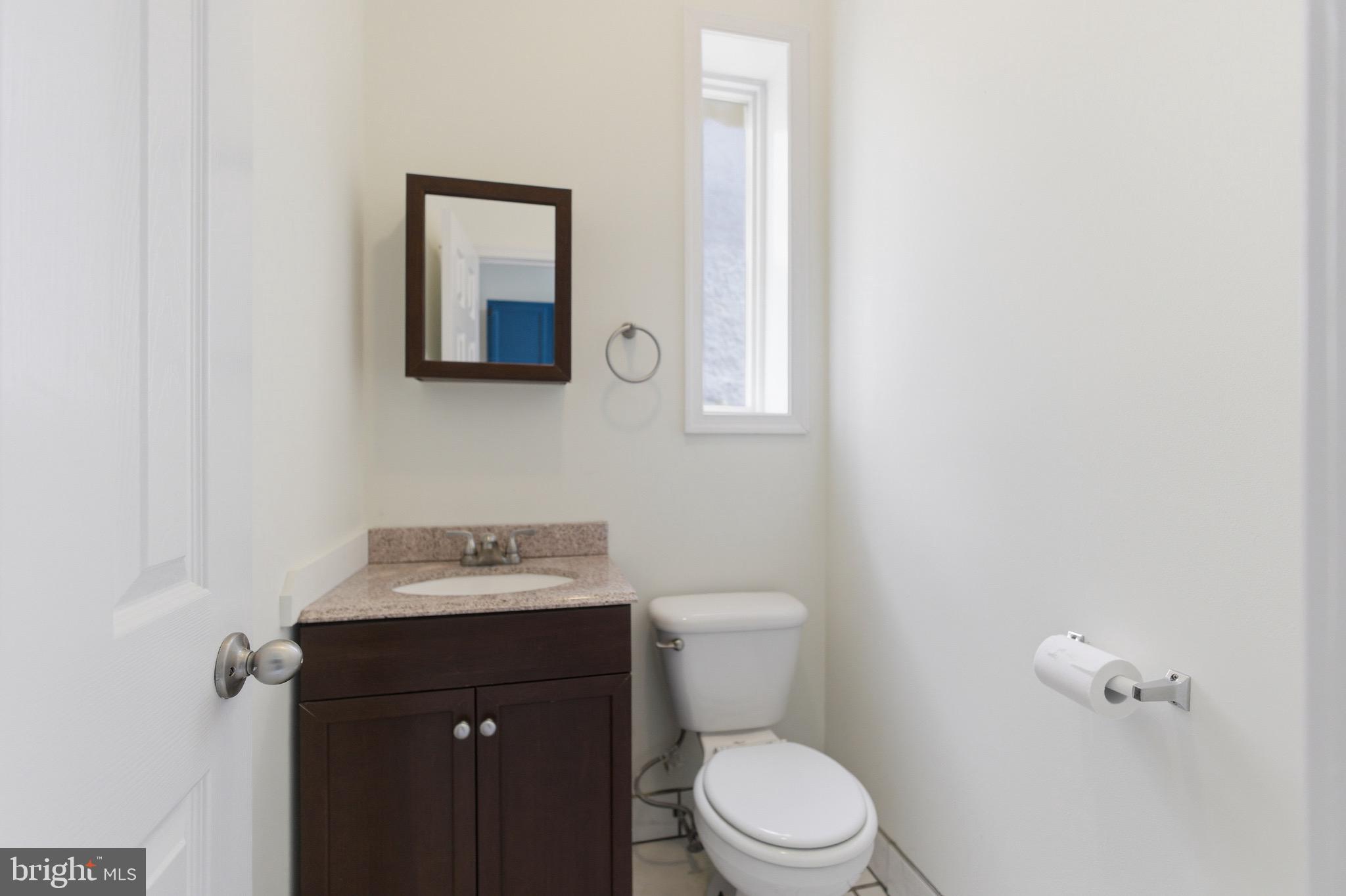 636 Columbia Road Northwest Washington, DC 20001 - Photo 18 of 60 a bathroom with a toilet sink and mirror