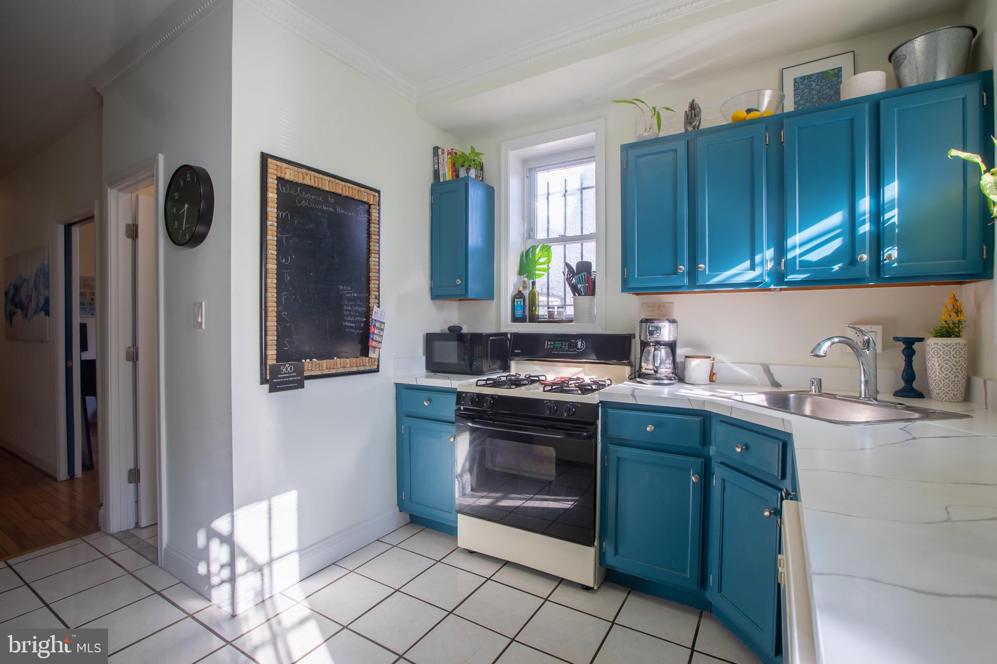 636 Columbia Road Northwest Washington, DC 20001 - Photo 22 of 60 a kitchen with stainless steel appliances granite countertop a stove a sink and a refrigerator
