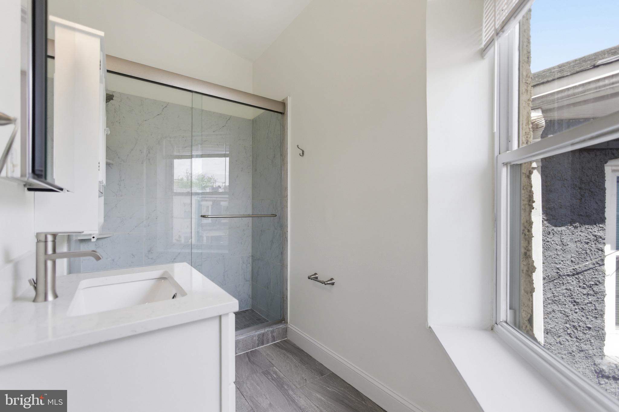 636 Columbia Road Northwest Washington, DC 20001 - Photo 41 of 60 a bathroom with a sink and mirror