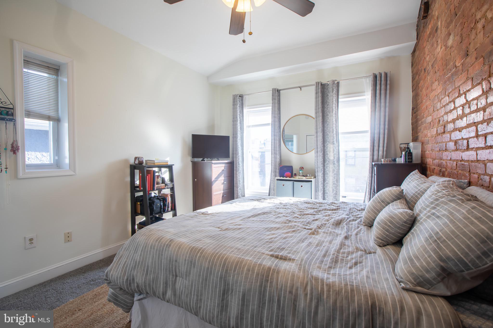 636 Columbia Road Northwest Washington, DC 20001 - Photo 42 of 60 a bedroom with a bed and a chandelier