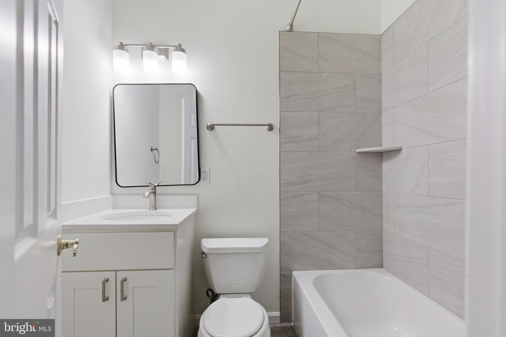 636 Columbia Road Northwest Washington, DC 20001 - Photo 43 of 60 a bathroom with a toilet sink and mirror
