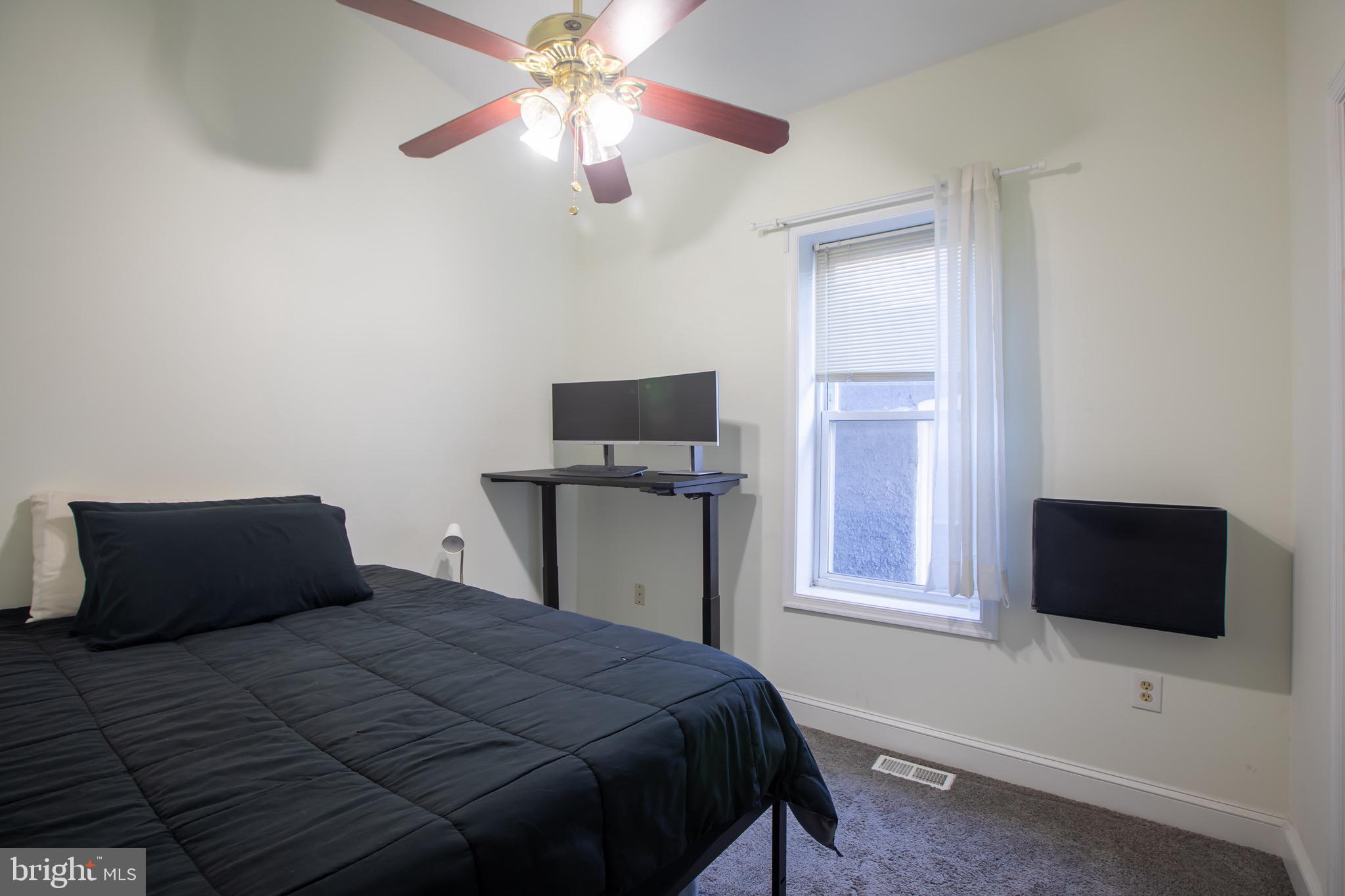 636 Columbia Road Northwest Washington, DC 20001 - Photo 48 of 60 a bedroom with a bed and a flat screen tv