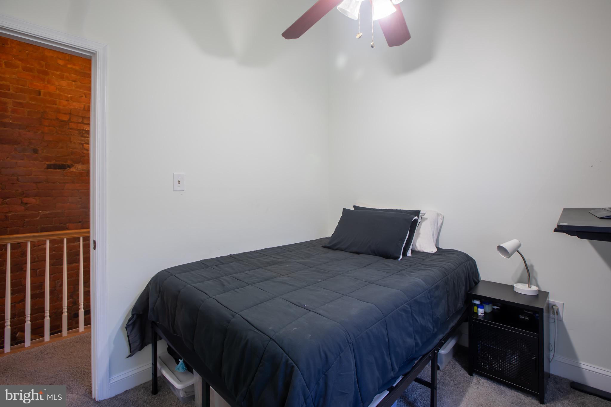636 Columbia Road Northwest Washington, DC 20001 - Photo 49 of 60 a bedroom with a bed and a lamp