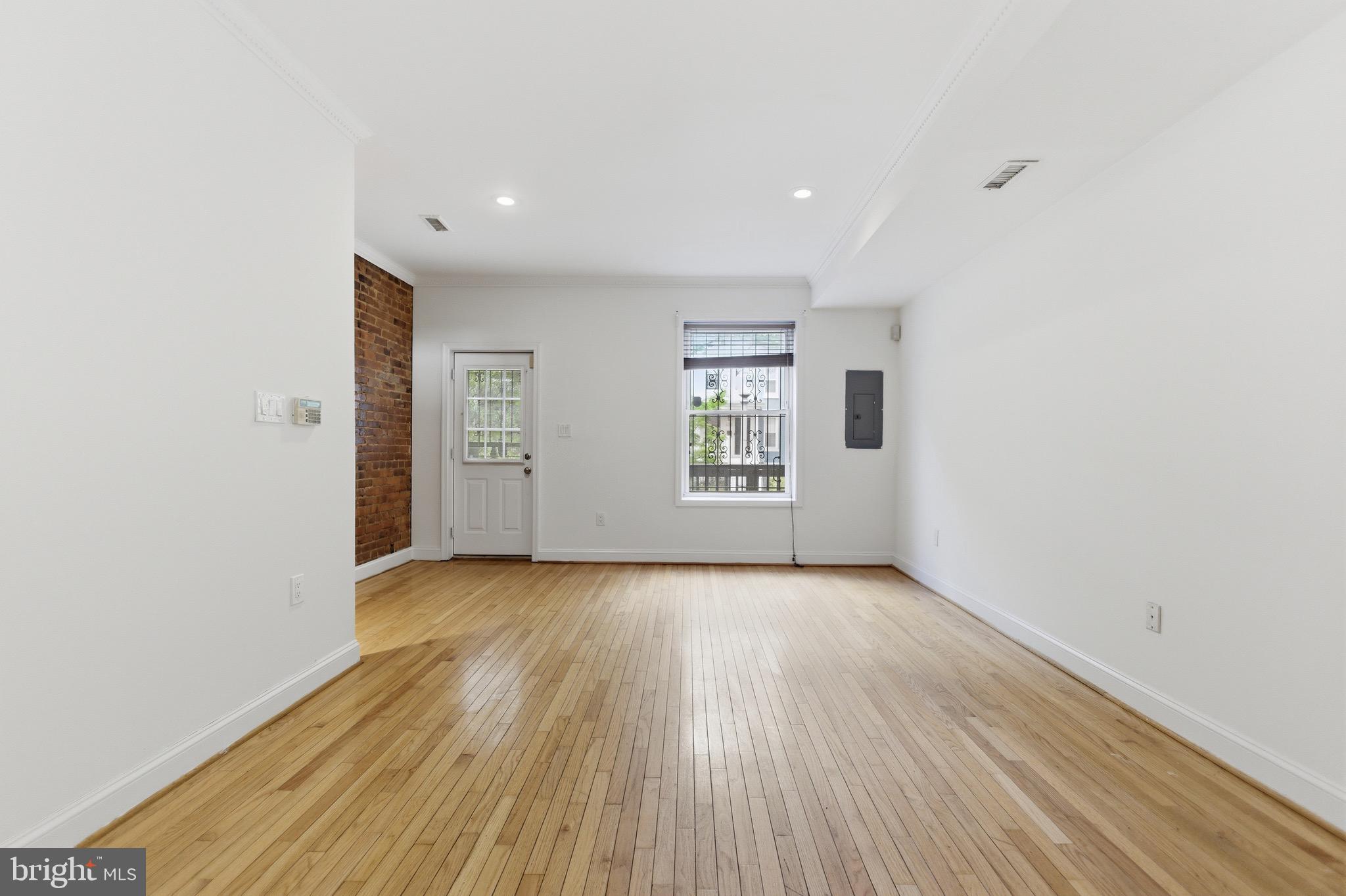 636 Columbia Road Northwest Washington, DC 20001 - Photo 6 of 60 an empty room with wooden floor and windows