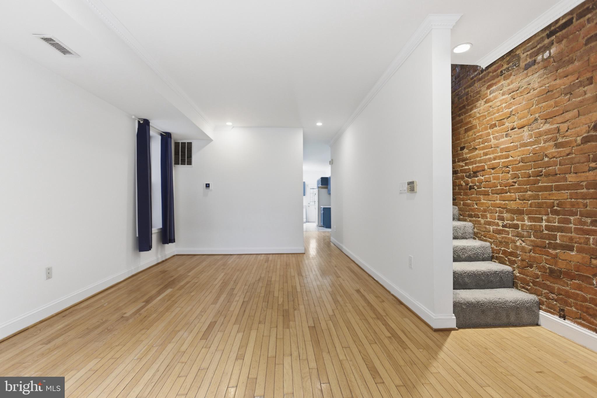 636 Columbia Road Northwest Washington, DC 20001 - Photo 8 of 60 a view of a hallway with wooden floor and staircase