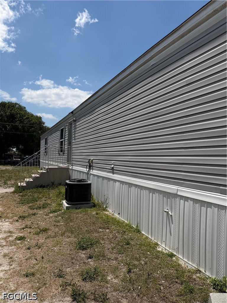 631 Stanton Street Clewiston, FL 33440 - Photo 3 of 24 a view of a house with backyard and a garden