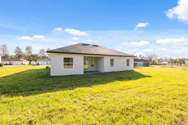 a view of a house with pool and a yard