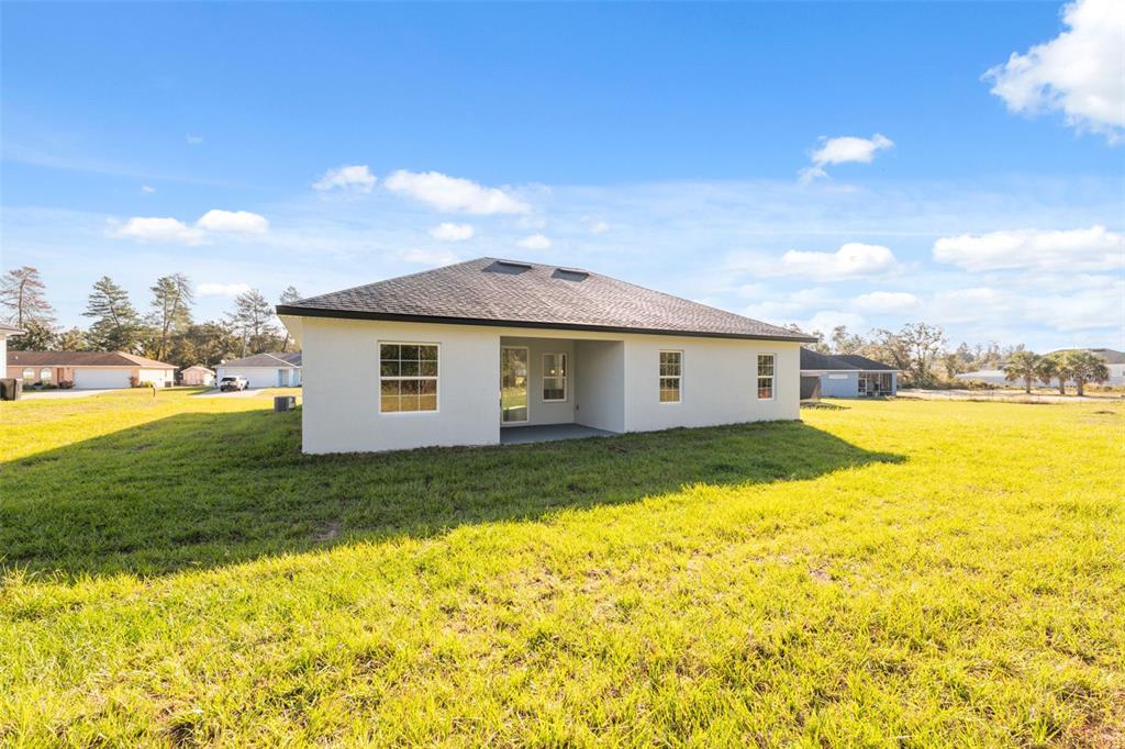 3350 Southwest 129th Loop Ocala, FL 34473 - Photo 31 of 33 a view of a house with pool and a yard