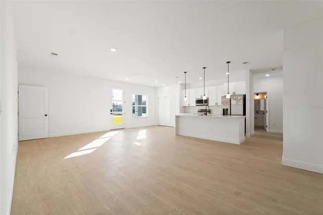 a view of a kitchen with a sink and a refrigerator