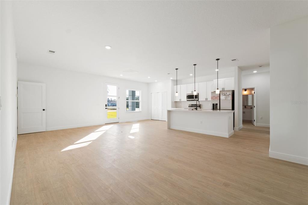 3350 Southwest 129th Loop Ocala, FL 34473 - Photo 8 of 33 a view of a kitchen with a sink and a refrigerator