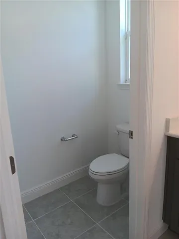 a white toilet sitting next to a sink