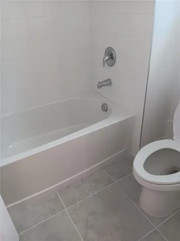 a bathroom with a toilet and a bathtub