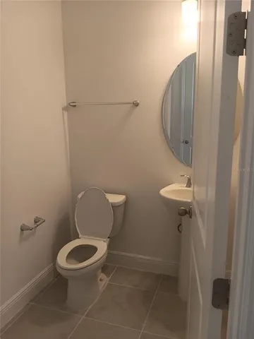 a bathroom with a toilet and a mirror