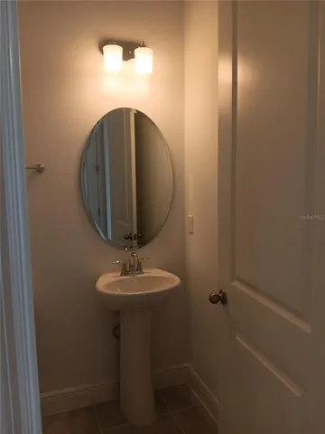 a bathroom with a sink and mirror