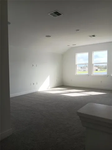 an empty room with a empty space and windows
