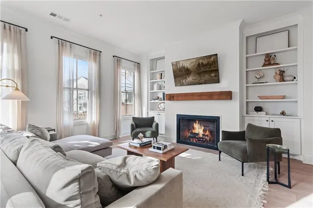 a living room with furniture and a potted plant