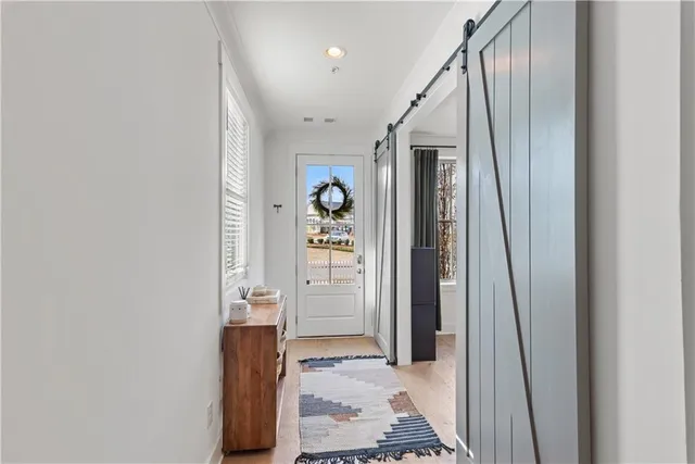 a living room with furniture a chandelier and a flat screen tv