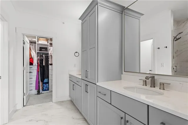 a bathroom with a granite countertop sink toilet and mirror