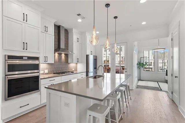 a kitchen with kitchen island a sink stove and refrigerator