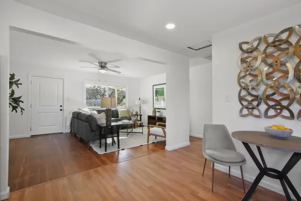 a living room with furniture and wooden floor