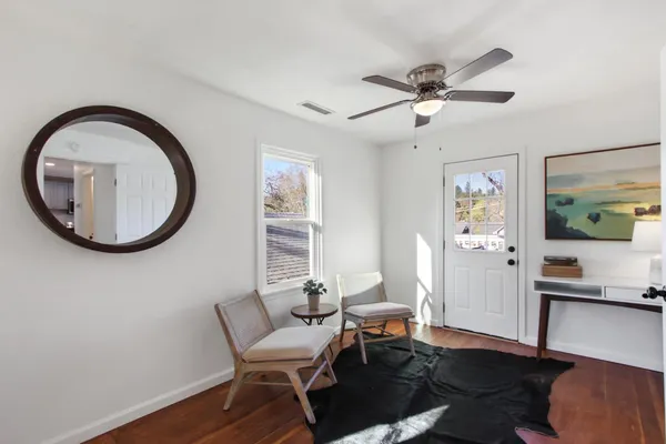 a view of a livingroom with furniture and a window