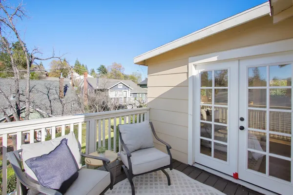 a balcony with table and chairs