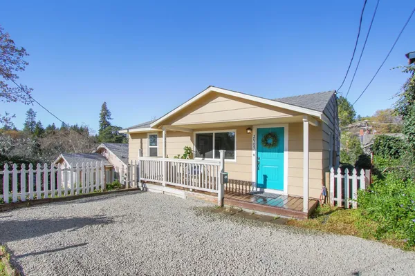 a view of a house with wooden fence
