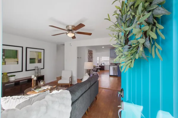 a living room with furniture and a potted plant