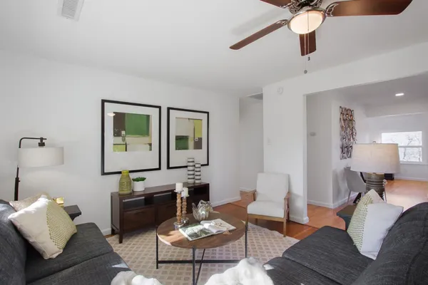 a living room with furniture and wooden floor
