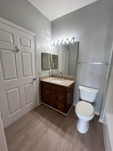 a bathroom with a toilet sink and mirror