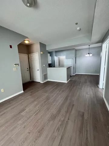 a view of a kitchen with wooden floor